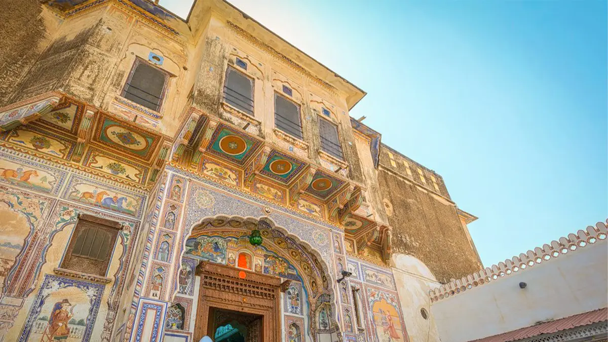 Traditional Rajput haveli entrance decorated with colorful fresco artwork
