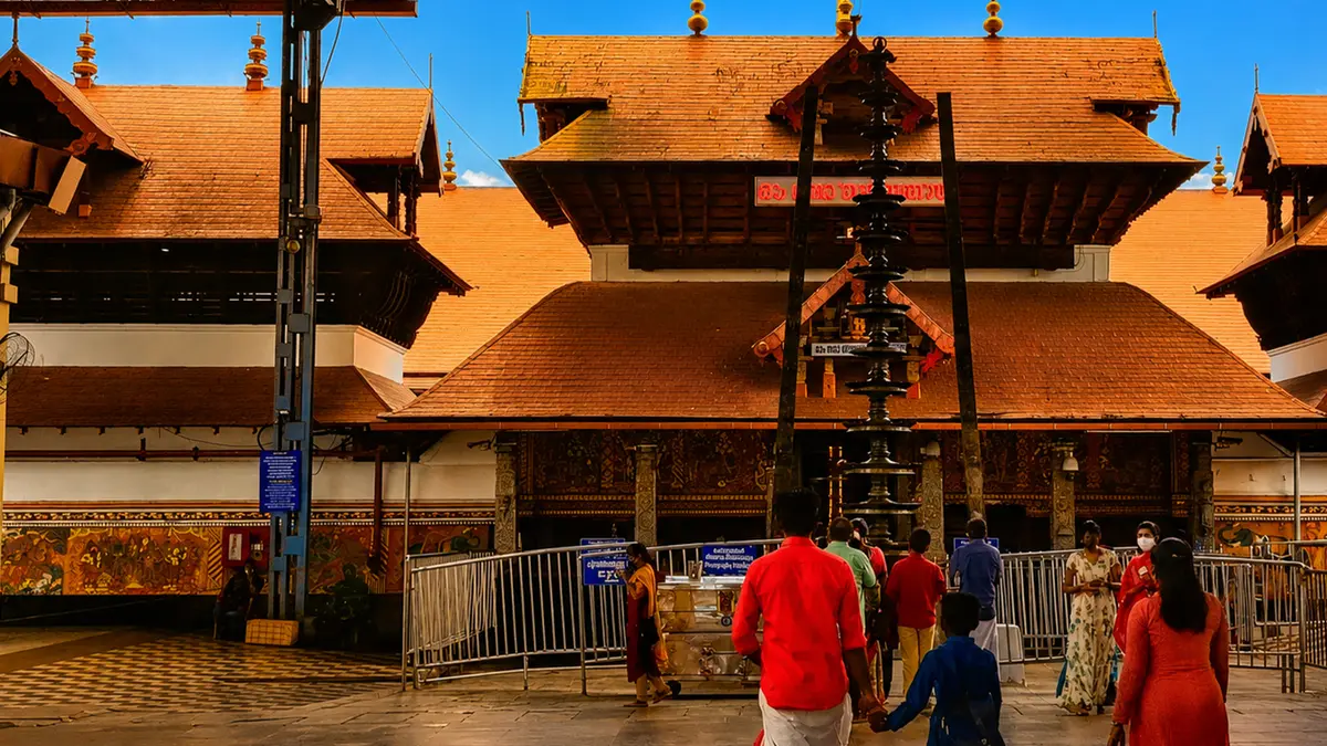 Pilgrims walking through the entrance pathway of a revered temple complex