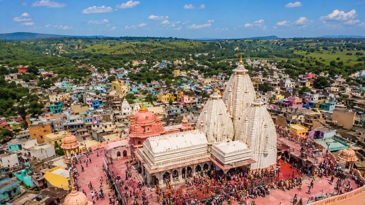 Aerial view of a major pilgrimage temple complex surrounded by devotees