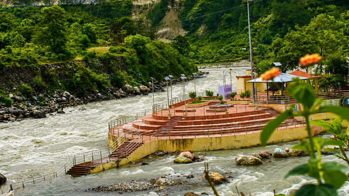 Peaceful riverside promenade surrounded by lush greenery and flowing waters