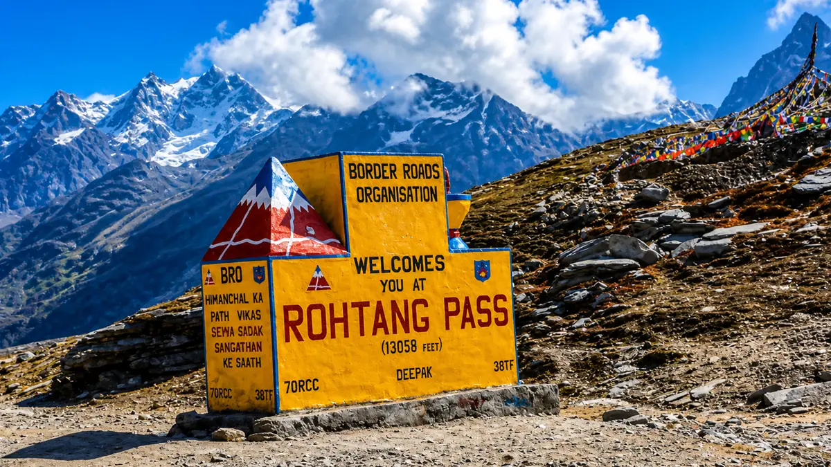 Welcome sign at Rohtang Pass with panoramic Himalayan mountain views in Himachal Pradesh