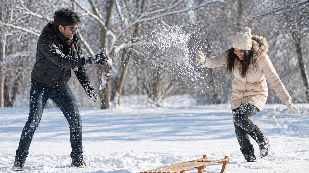 Couple playing in Kashmir snowfall
