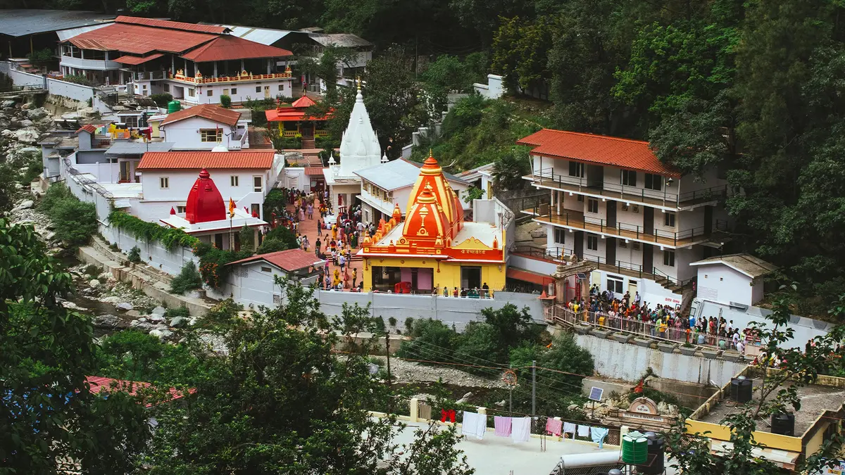 Spiritual ashram complex nestled among forested Himalayan hills