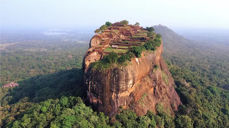 Aerial view of the iconic Sigiriya Rock Fortress rising above Sri Lanka's tropical landscape