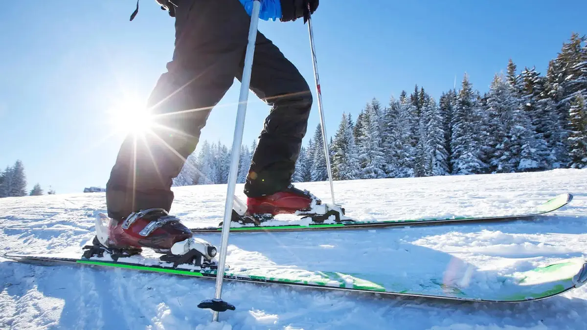 Winter sports enthusiast skiing across snow-covered alpine terrain