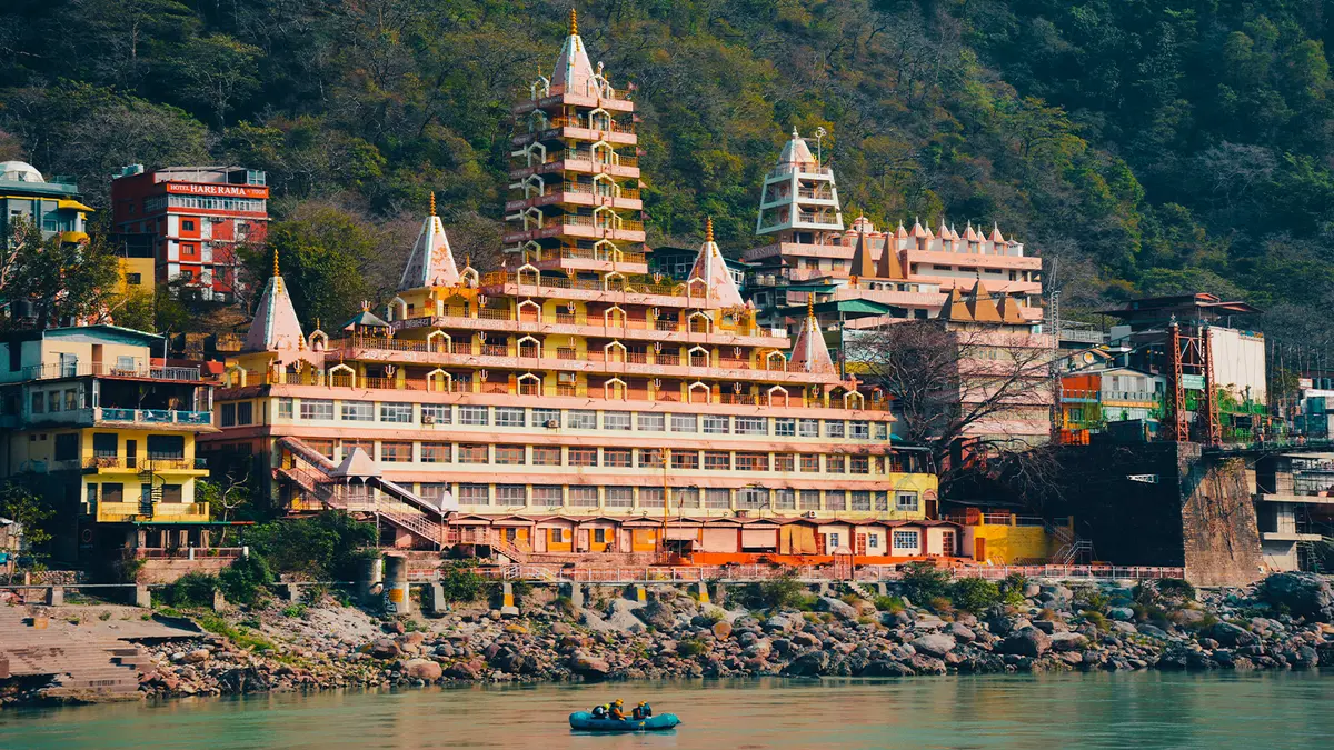 Large spiritual retreat complex overlooking a serene river landscape