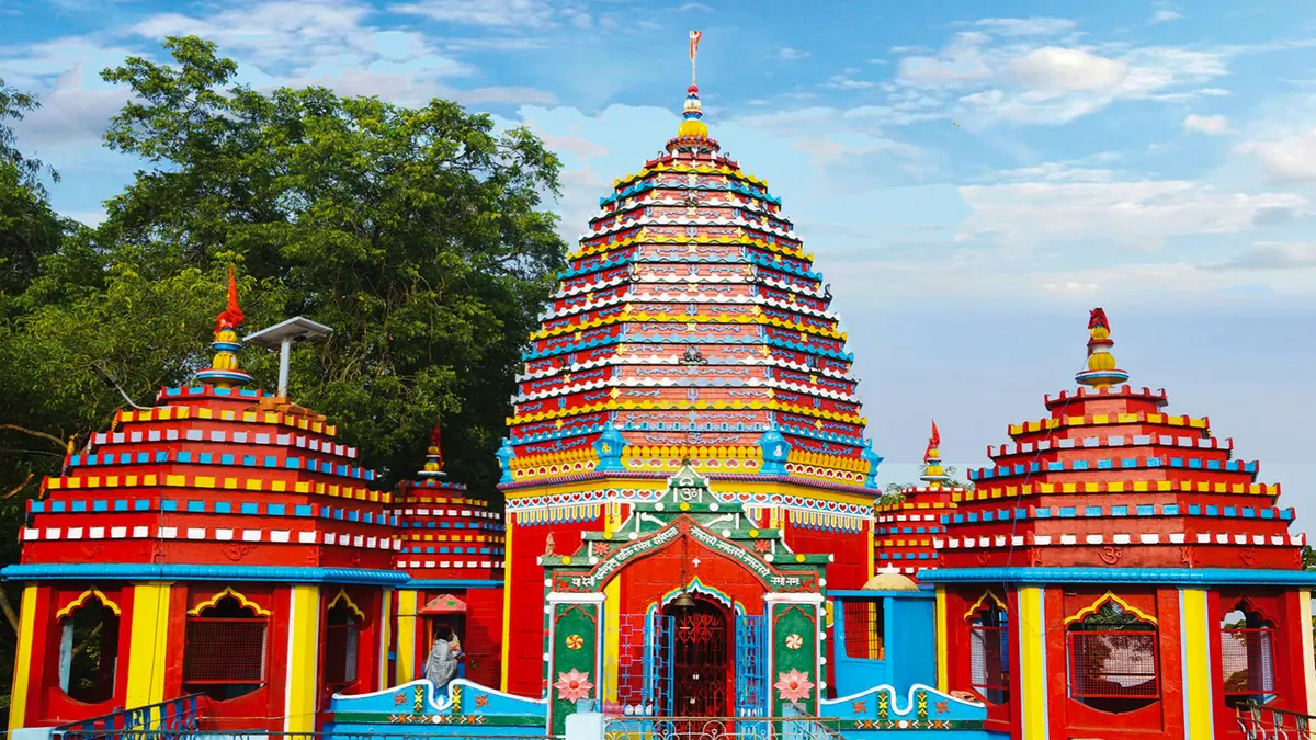Colorful Sri Sri Mahamaya Temple in Assam surrounded by greenery