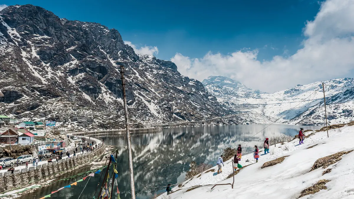 Snow-covered Tsomgo (Changu) Lake surrounded by Himalayan peaks in East Sikkim