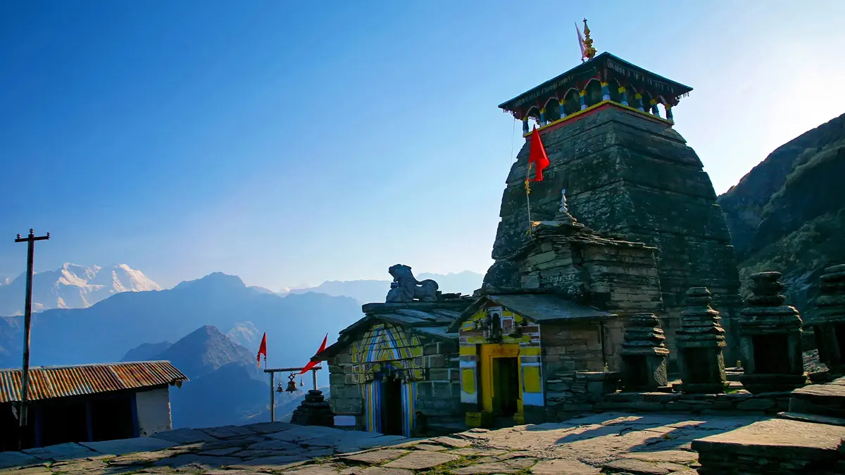 Ancient Tungnath temple shrine set against Himalayan mountain views