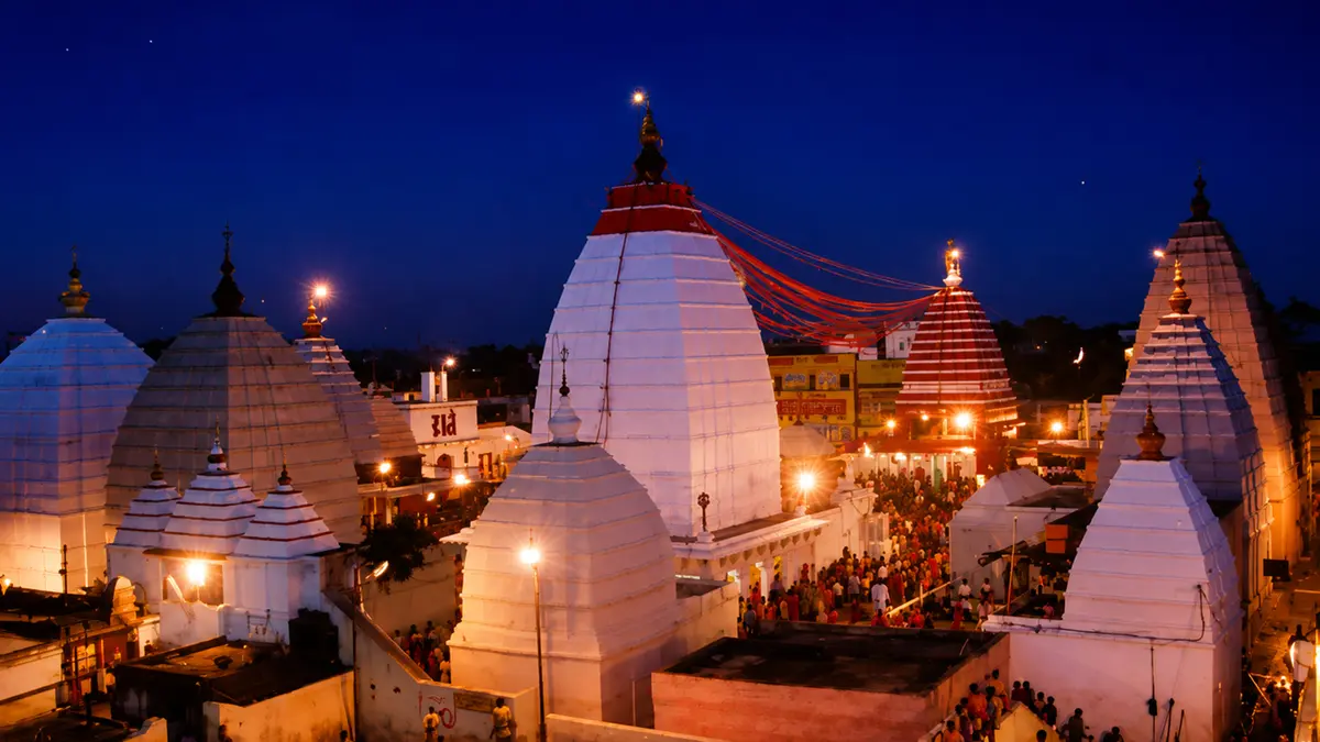 Illuminated sacred precinct filled with devotees during evening worship ceremonies
