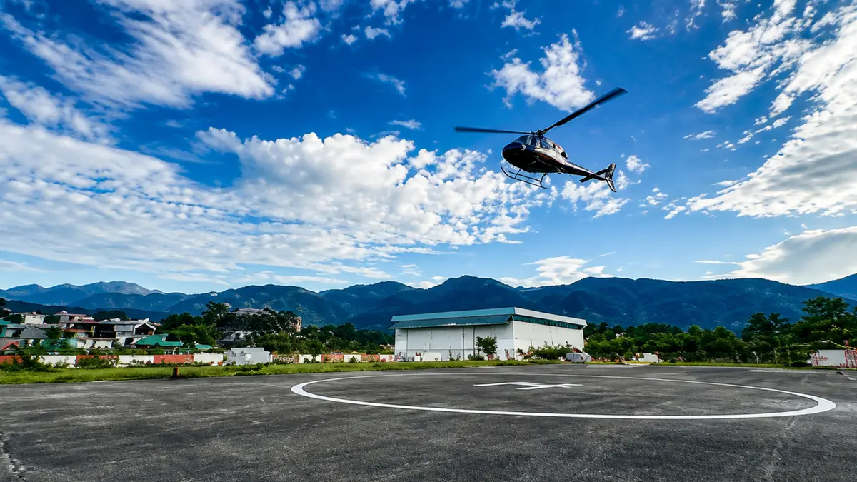 Helicopter taking off from a helipad in Uttarakhand