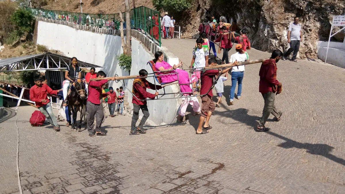 Pilgrims walking on the Vaishno Devi trekking route toward Bhawan