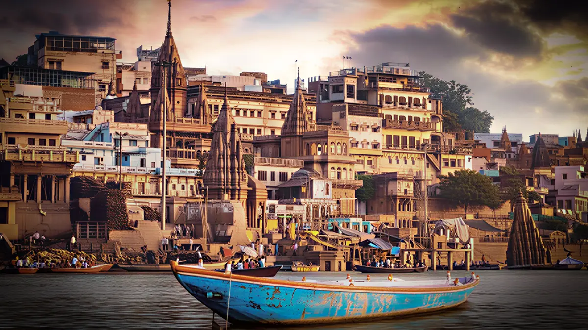 Traditional boat sailing past the sacred ghats of Varanasi