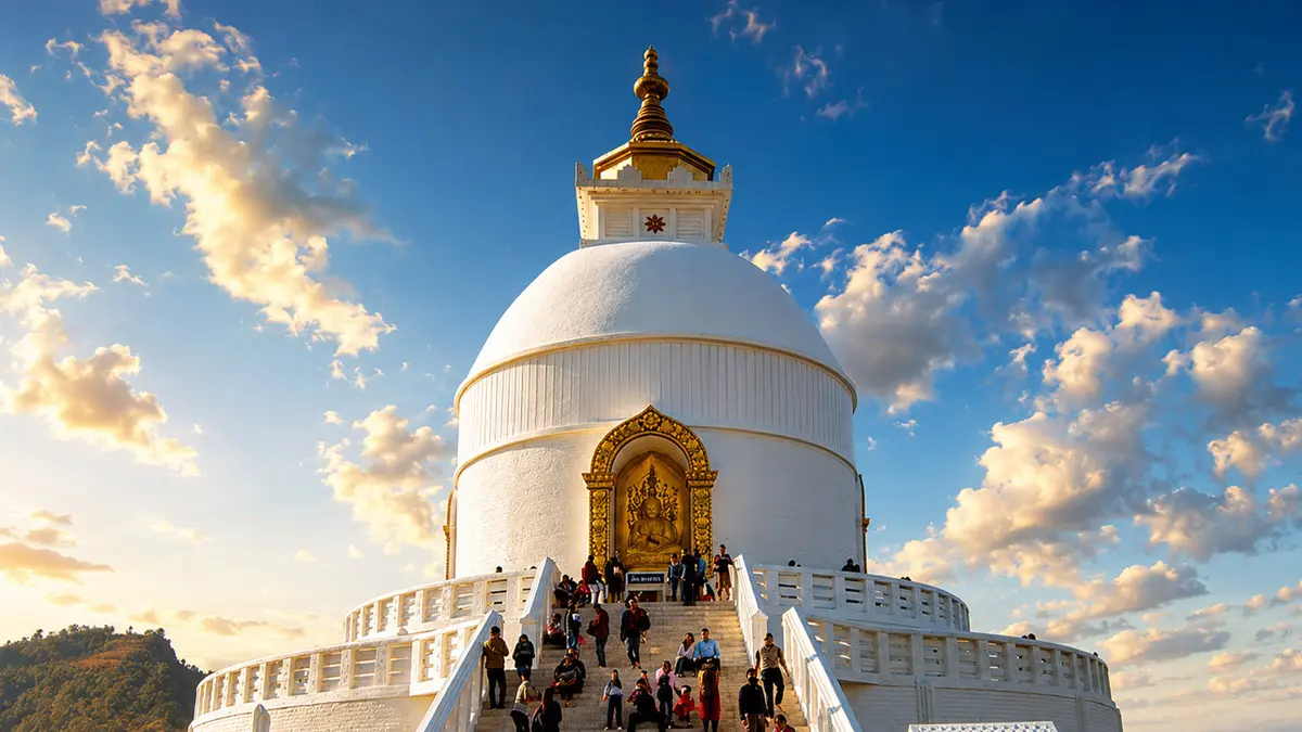 Visitors ascending a white peace pagoda overlooking scenic landscapes