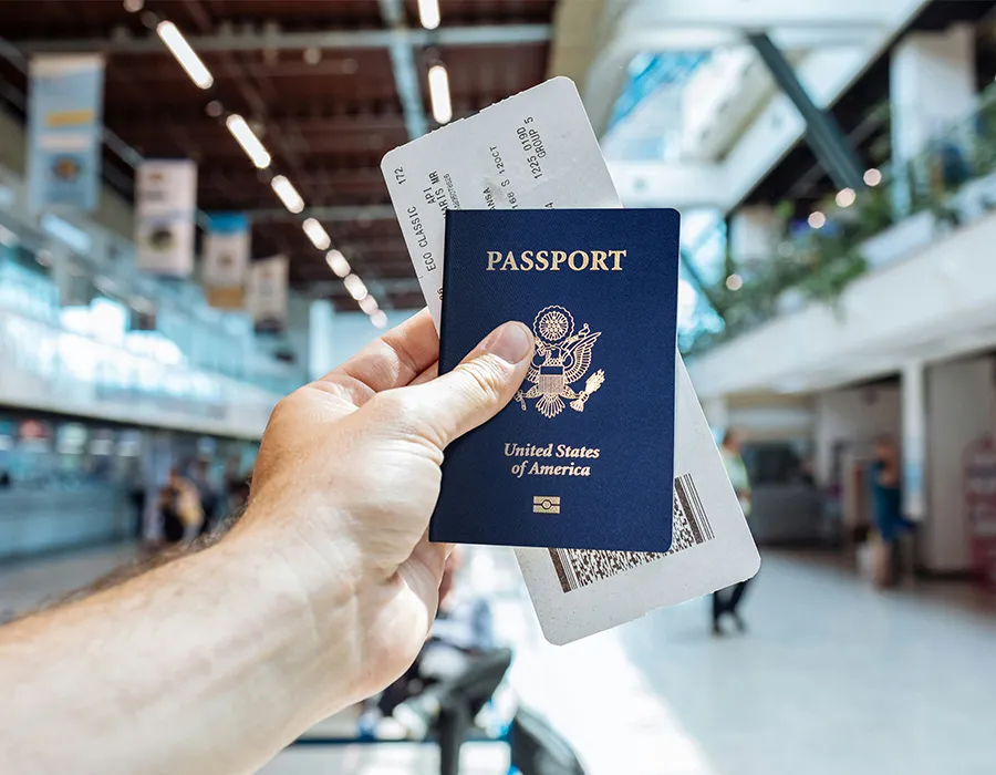 Passport camera and travel essentials arranged for an international journey
